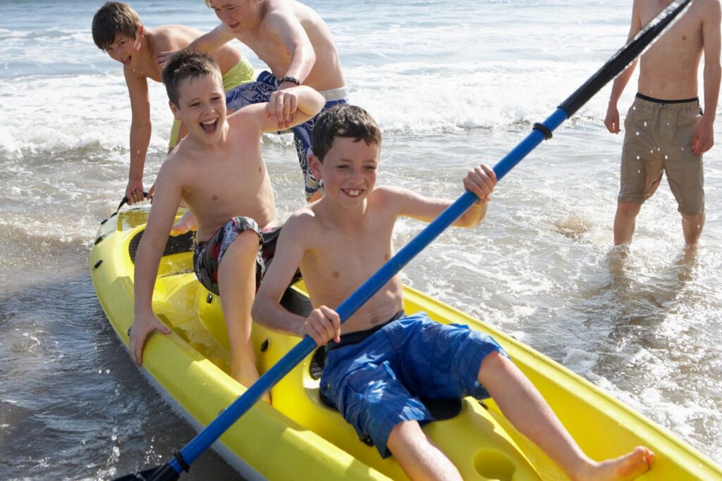 Teens kayaking in water